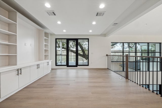 interior space with built in features and light hardwood / wood-style flooring