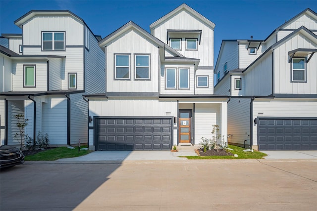 view of front of home with board and batten siding, concrete driveway, and a garage