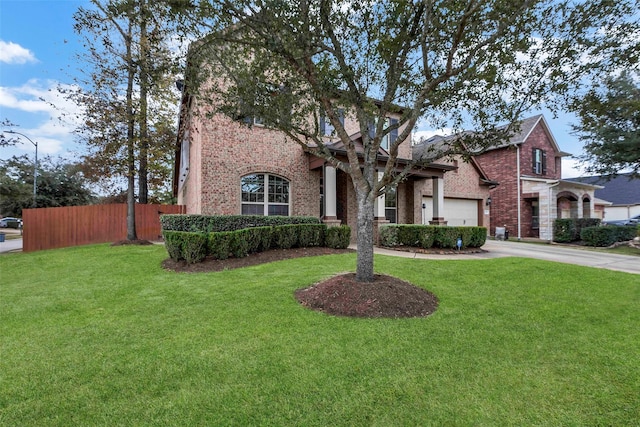 view of front of house with a front yard and a garage