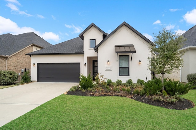 view of front of house featuring a front yard and a garage