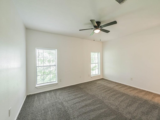 carpeted spare room with ceiling fan