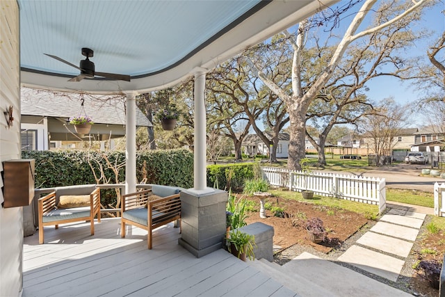 deck with ceiling fan and fence