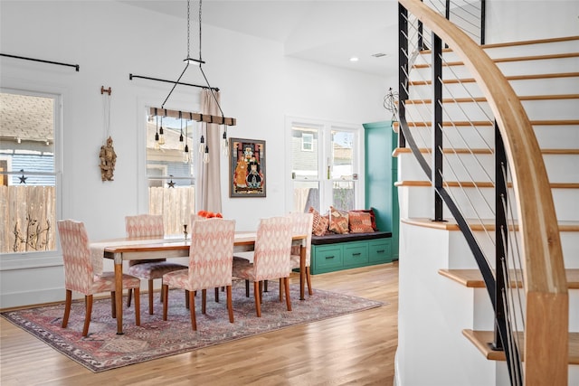 dining room with recessed lighting, stairs, and wood finished floors