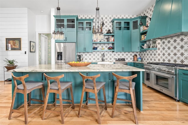 kitchen with premium range hood, a kitchen island, open shelves, light wood-style flooring, and premium appliances