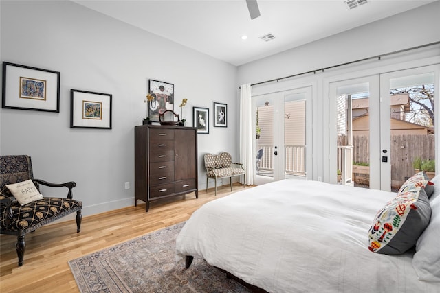 bedroom with access to exterior, wood finished floors, french doors, and visible vents