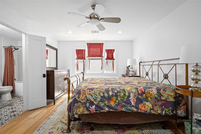 bedroom with recessed lighting, ensuite bath, a ceiling fan, and wood finished floors