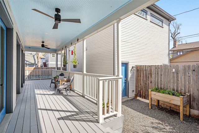 deck with a ceiling fan and fence