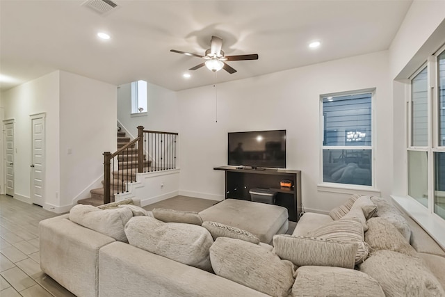 living room featuring light wood-type flooring and ceiling fan