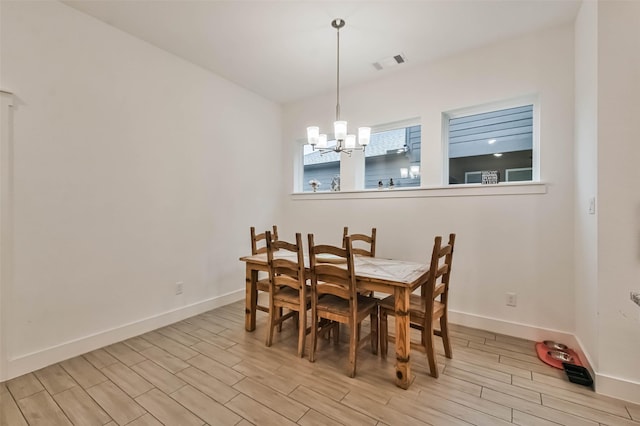 dining space with an inviting chandelier