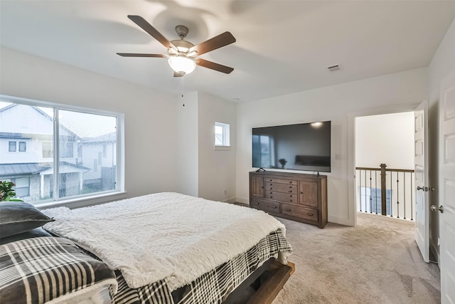 bedroom with light colored carpet and ceiling fan