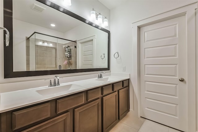 bathroom featuring tile patterned flooring, an enclosed shower, and vanity