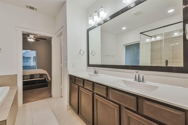 bathroom featuring ceiling fan, vanity, plus walk in shower, and tile patterned floors