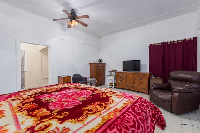 tiled bedroom featuring ceiling fan