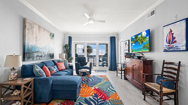 living room with ceiling fan, light hardwood / wood-style flooring, and crown molding