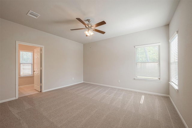 carpeted empty room featuring ceiling fan