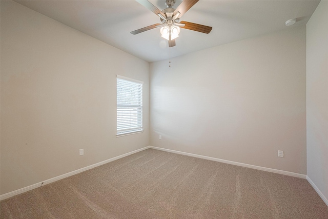 carpeted spare room featuring ceiling fan