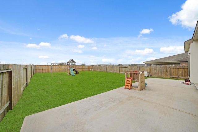 view of yard featuring a fenced backyard, a playground, and a patio