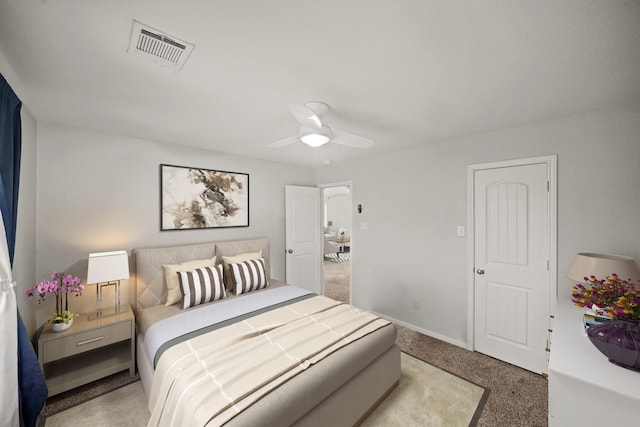 bedroom featuring baseboards, visible vents, a ceiling fan, and light colored carpet