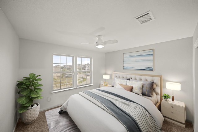 bedroom with carpet floors, ceiling fan, visible vents, and baseboards