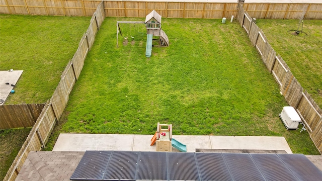 view of yard featuring a playground and a fenced backyard