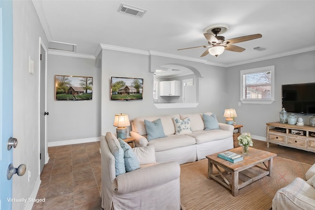 living area with a ceiling fan, crown molding, baseboards, and visible vents