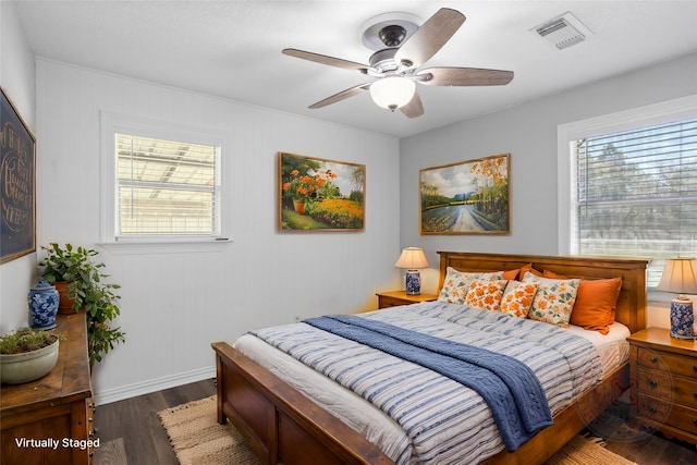 bedroom with visible vents, multiple windows, baseboards, and wood finished floors