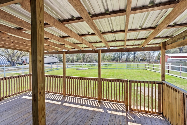 wooden terrace featuring a yard and fence