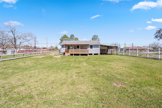 back of house featuring a wooden deck, a yard, and fence