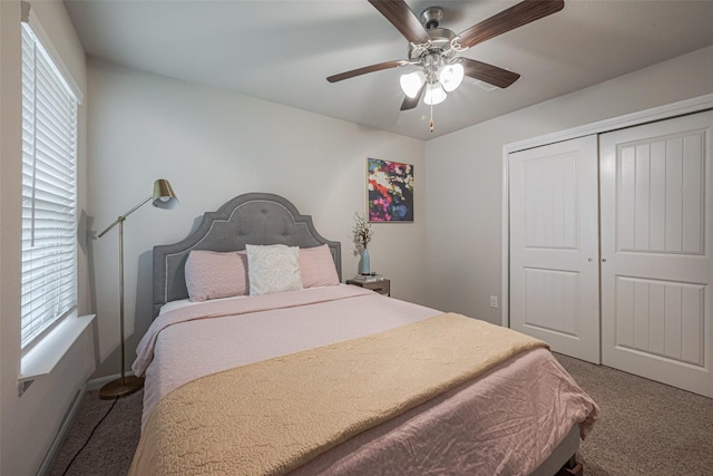 carpeted bedroom with ceiling fan and a closet