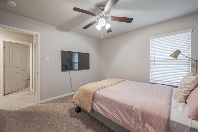 bedroom with ceiling fan and light colored carpet