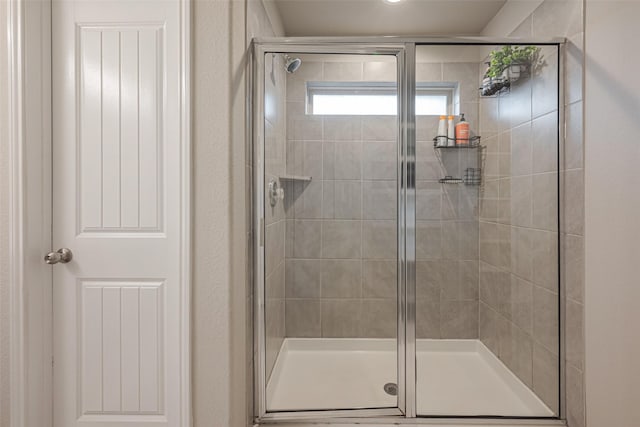 bathroom with a shower with shower door