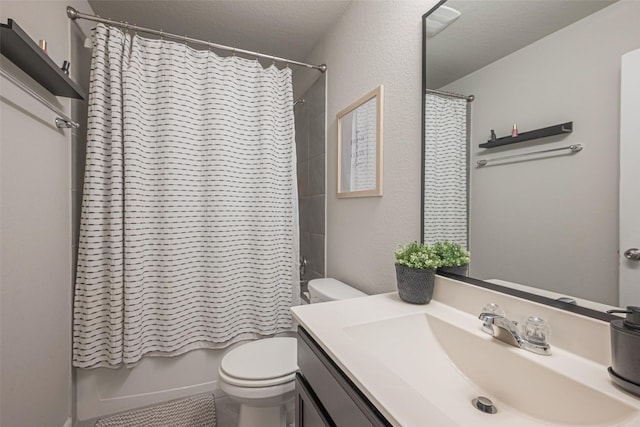 full bathroom featuring toilet, shower / bath combination with curtain, and vanity