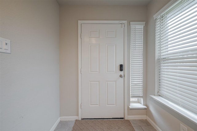 doorway to outside featuring plenty of natural light and light tile patterned floors