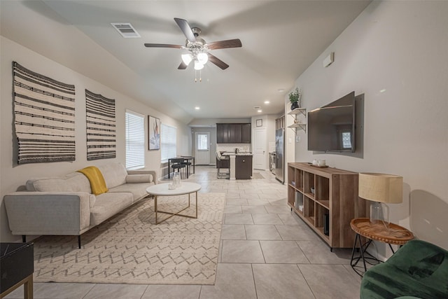 tiled living room with ceiling fan