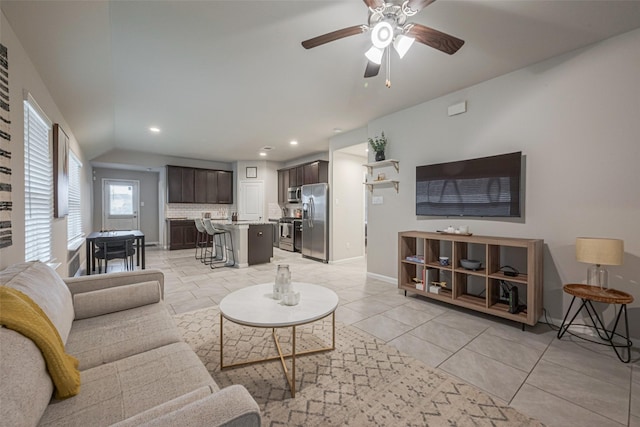 living room featuring light tile patterned flooring, lofted ceiling, and ceiling fan