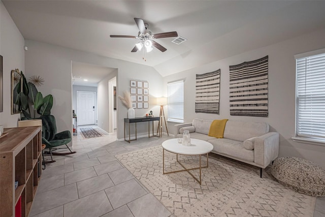 tiled living room featuring ceiling fan and lofted ceiling