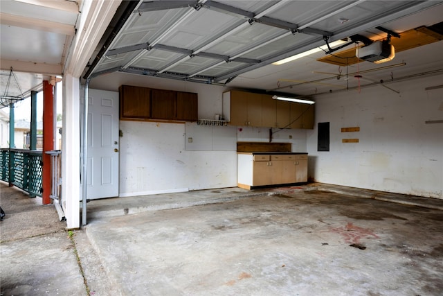 garage with electric panel and a garage door opener