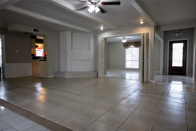 tiled entrance foyer featuring beam ceiling and ceiling fan
