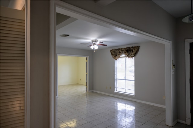 unfurnished room with ceiling fan and light tile patterned floors