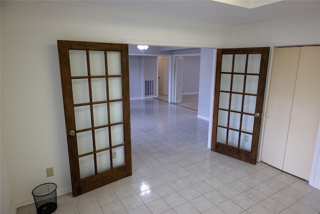 tiled empty room with french doors
