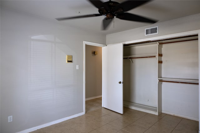 unfurnished bedroom with a closet, ceiling fan, and light tile patterned floors