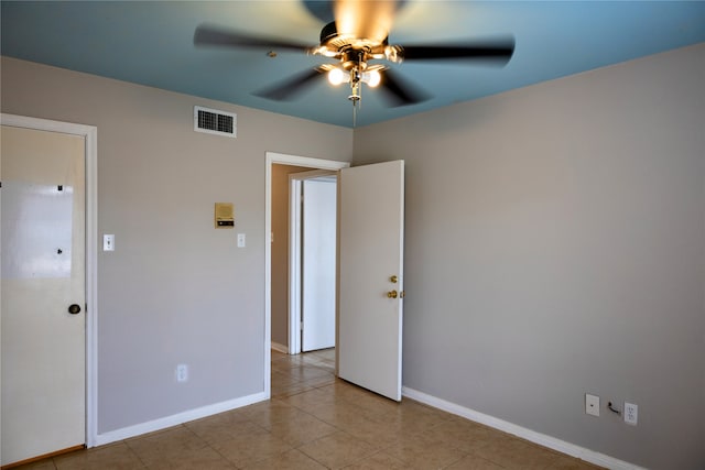 unfurnished bedroom with light tile patterned flooring and ceiling fan
