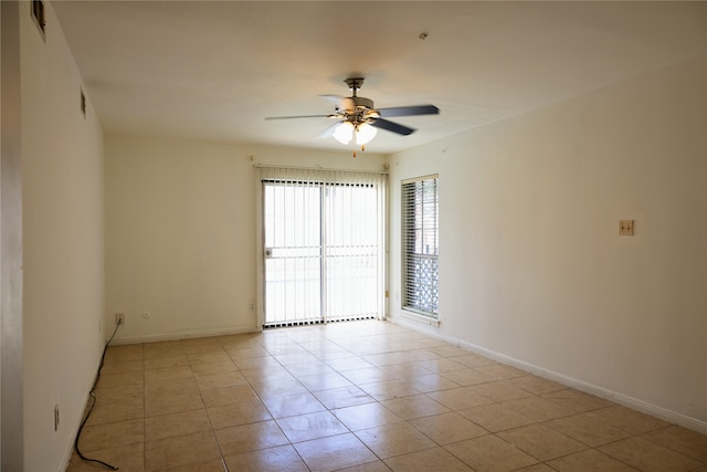 tiled empty room featuring ceiling fan