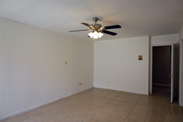 empty room featuring light tile patterned floors and ceiling fan