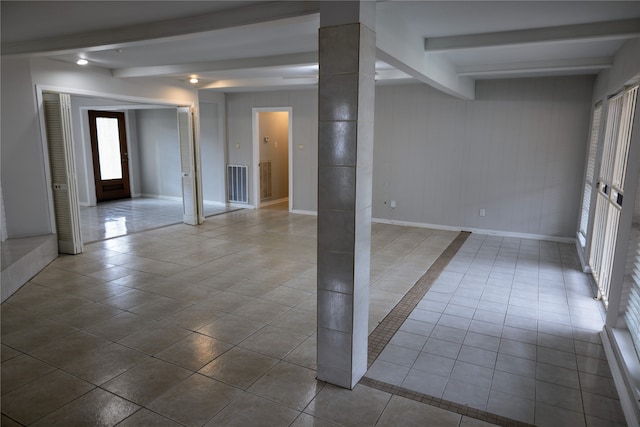 tiled spare room with ornate columns and beam ceiling