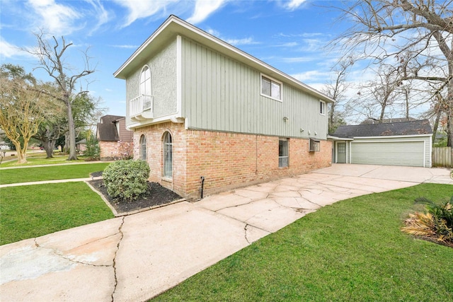 view of side of home featuring a garage, a yard, and brick siding