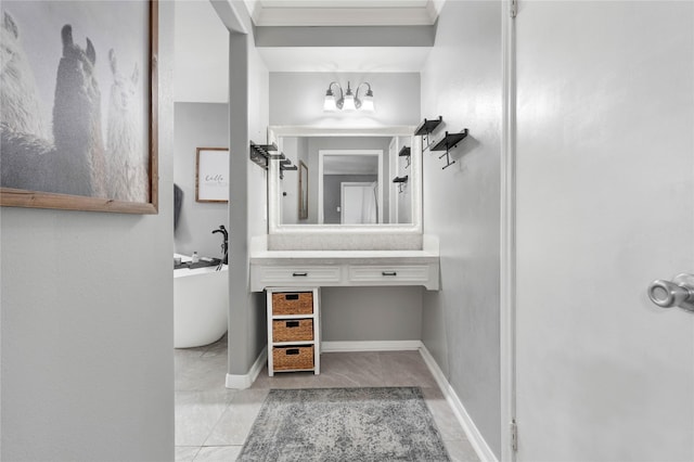 full bath featuring a soaking tub, vanity, and baseboards