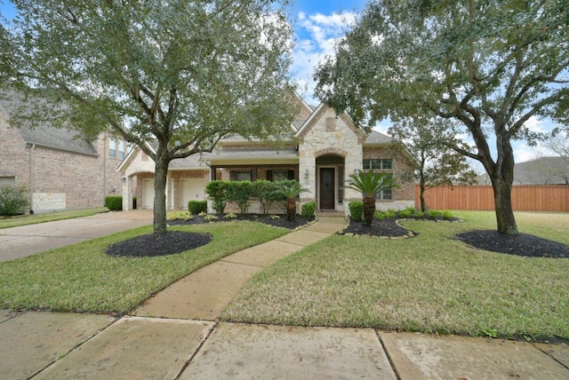 view of front of home with a front lawn and a garage