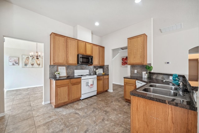 kitchen with a notable chandelier, white range with gas cooktop, backsplash, light tile patterned floors, and sink