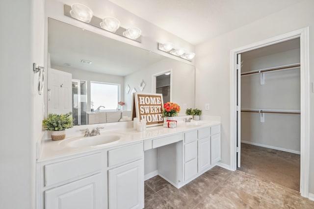 bathroom with vanity and a shower with door